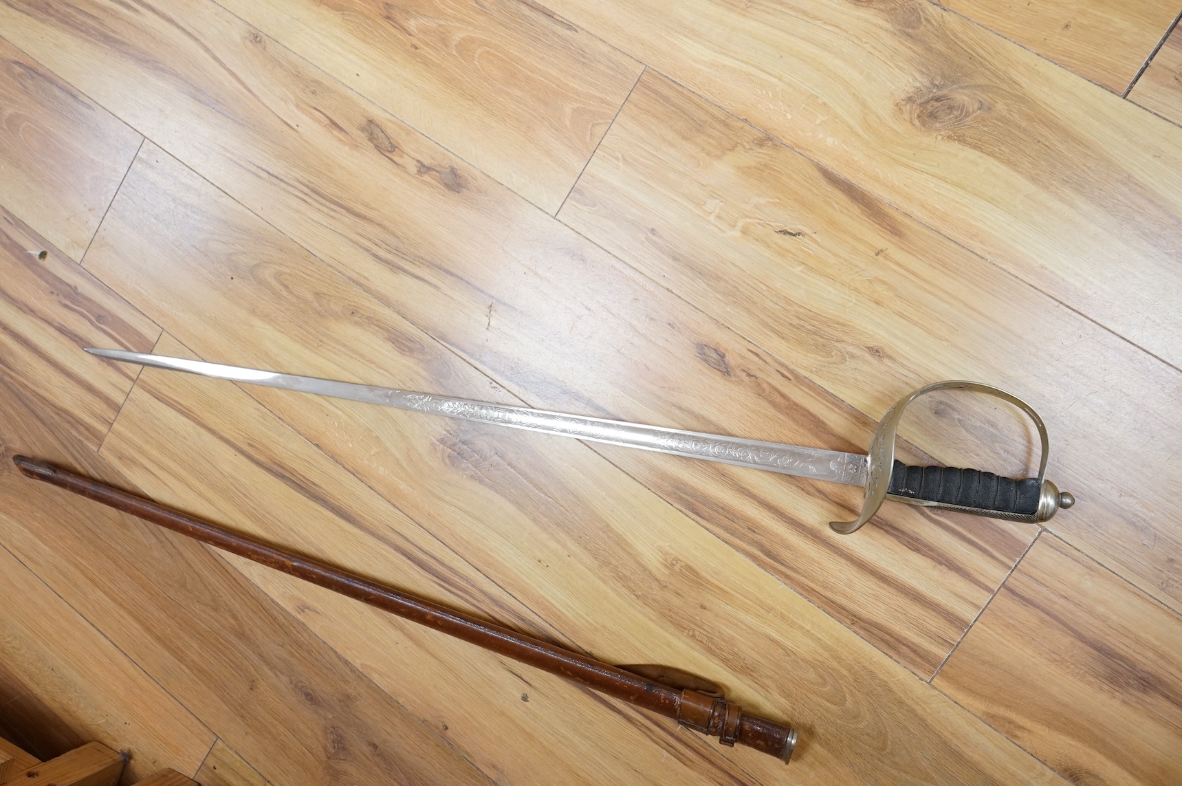 A George V 1897 pattern infantry officer’s sword, with regulation blade etched with the union flowers, Royal Arms and owners name; J.W. Reynolds, Dorrington, Lincoln, regulation nickel guard stamped ‘WH&S’ in minuscules,